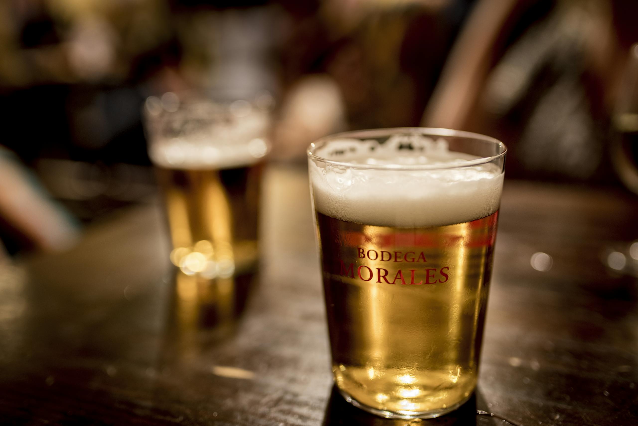 Close-up of a frothy beer in a Bodega Morales glass, Sevilla.